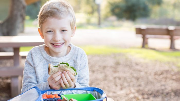 Child eating lunch outside